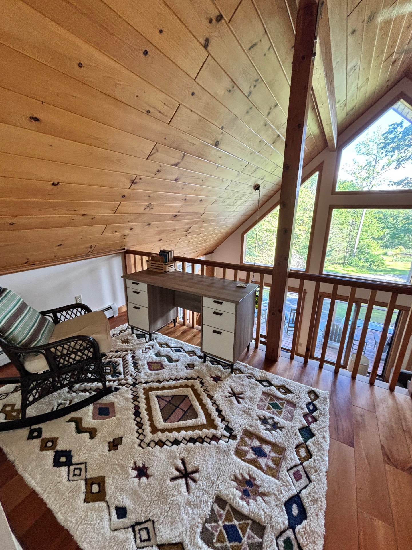 Loft with vaulted ceiling and rocking chair