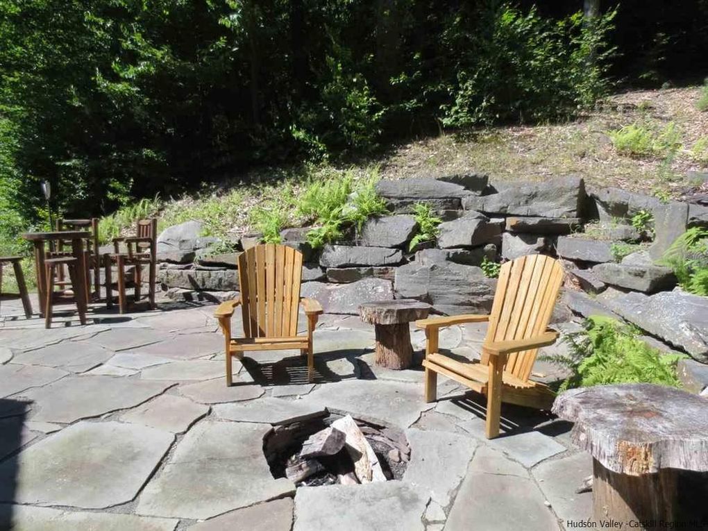 Stone firepit with adirondack chairs