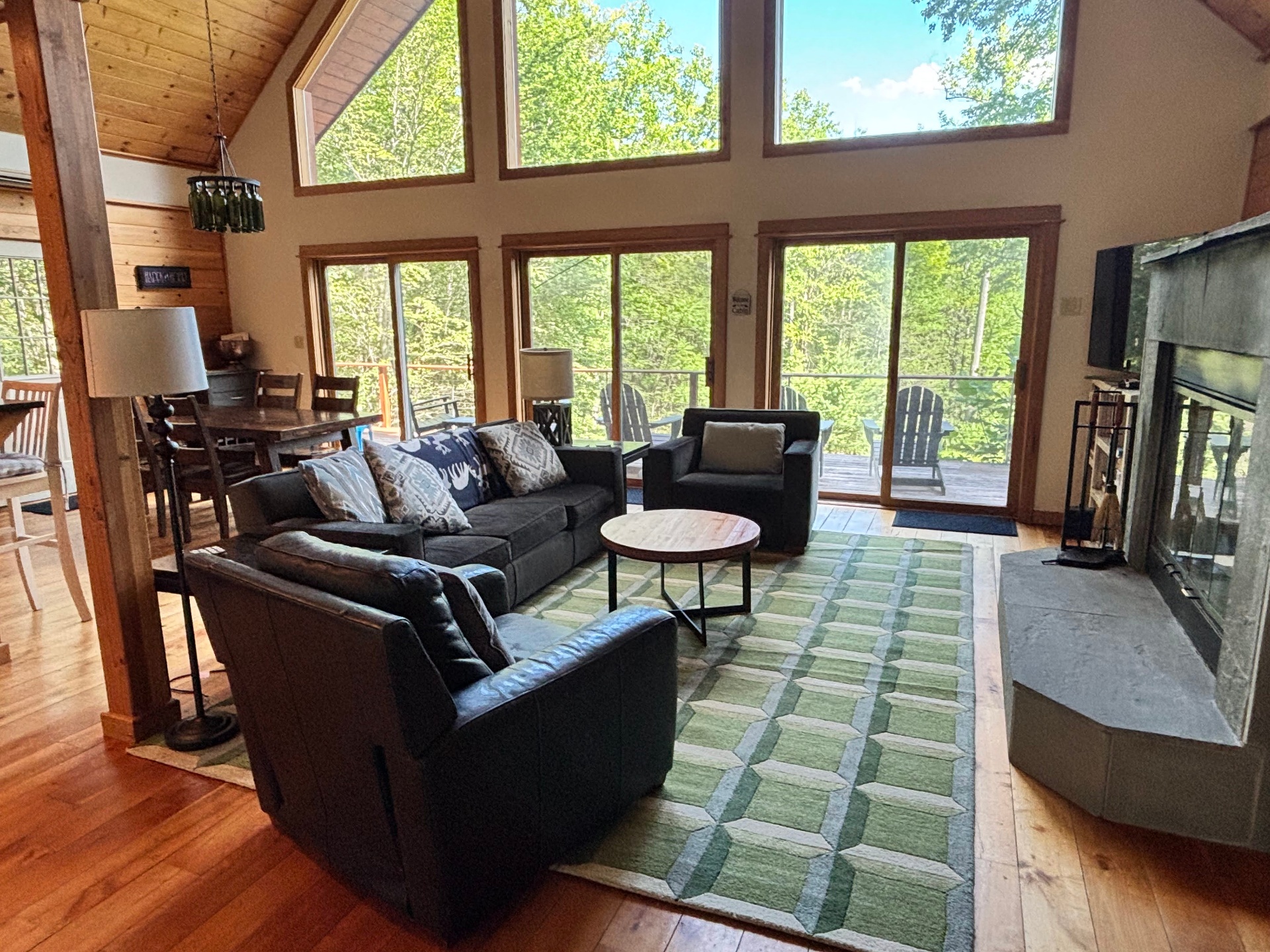 Living room with leather couches and stone fireplace