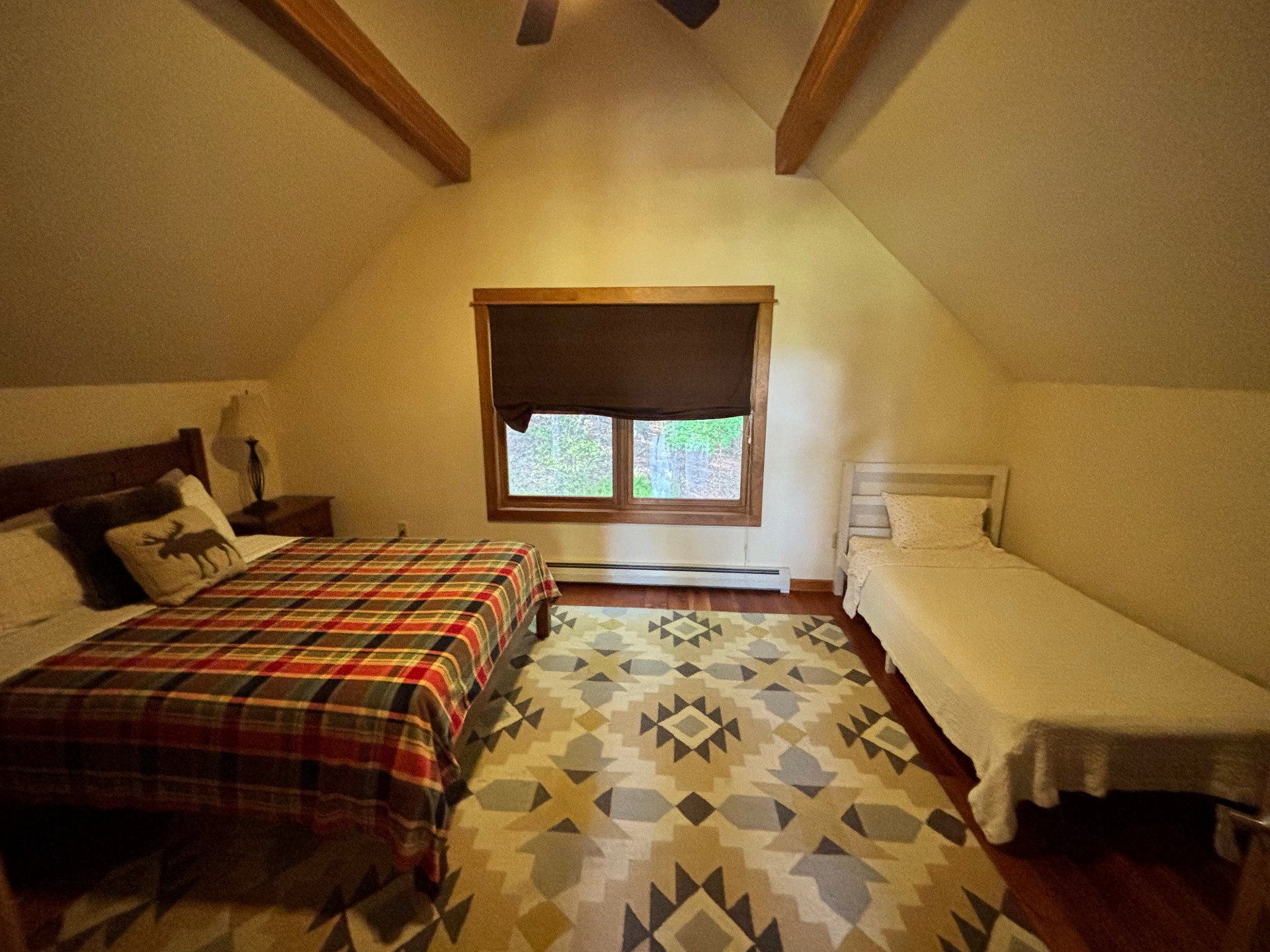 Loft bedroom with queen bed and twin under vaulted ceiling