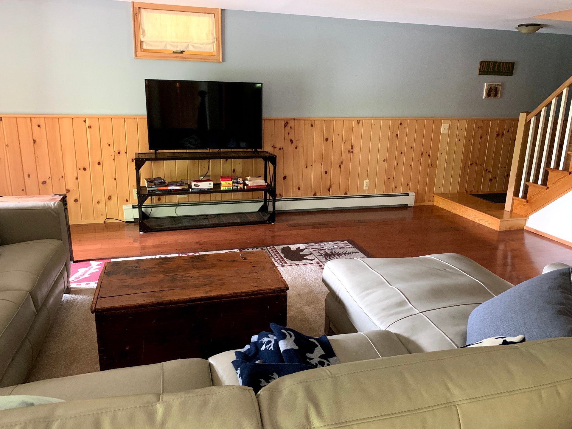 Downstairs lounge with big TV and sectional