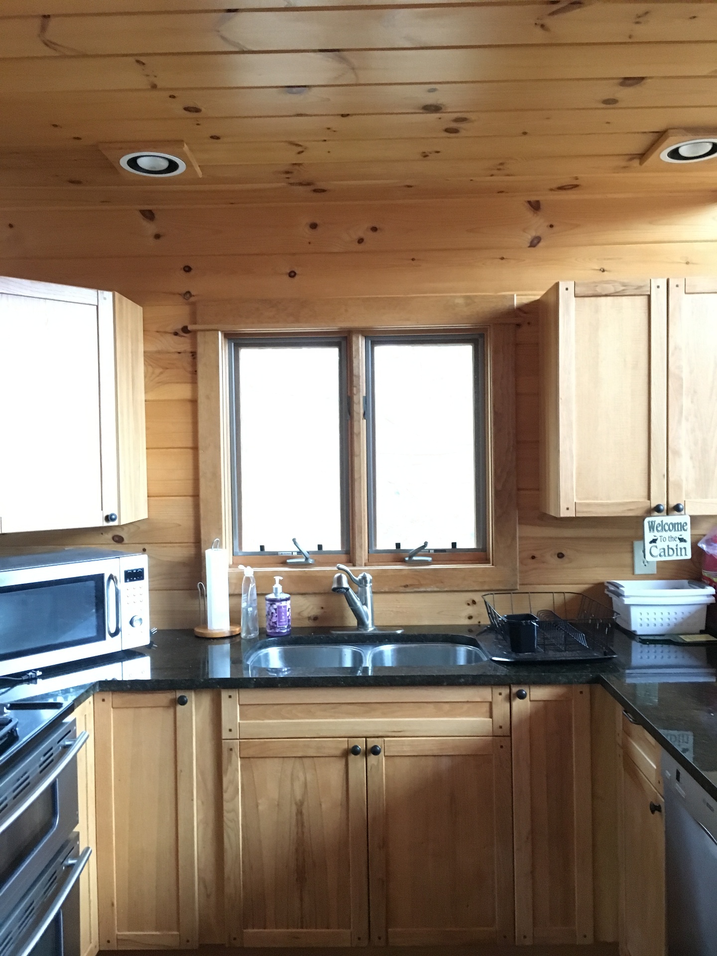 Cabin kitchen with pine cabinetry and granite counters