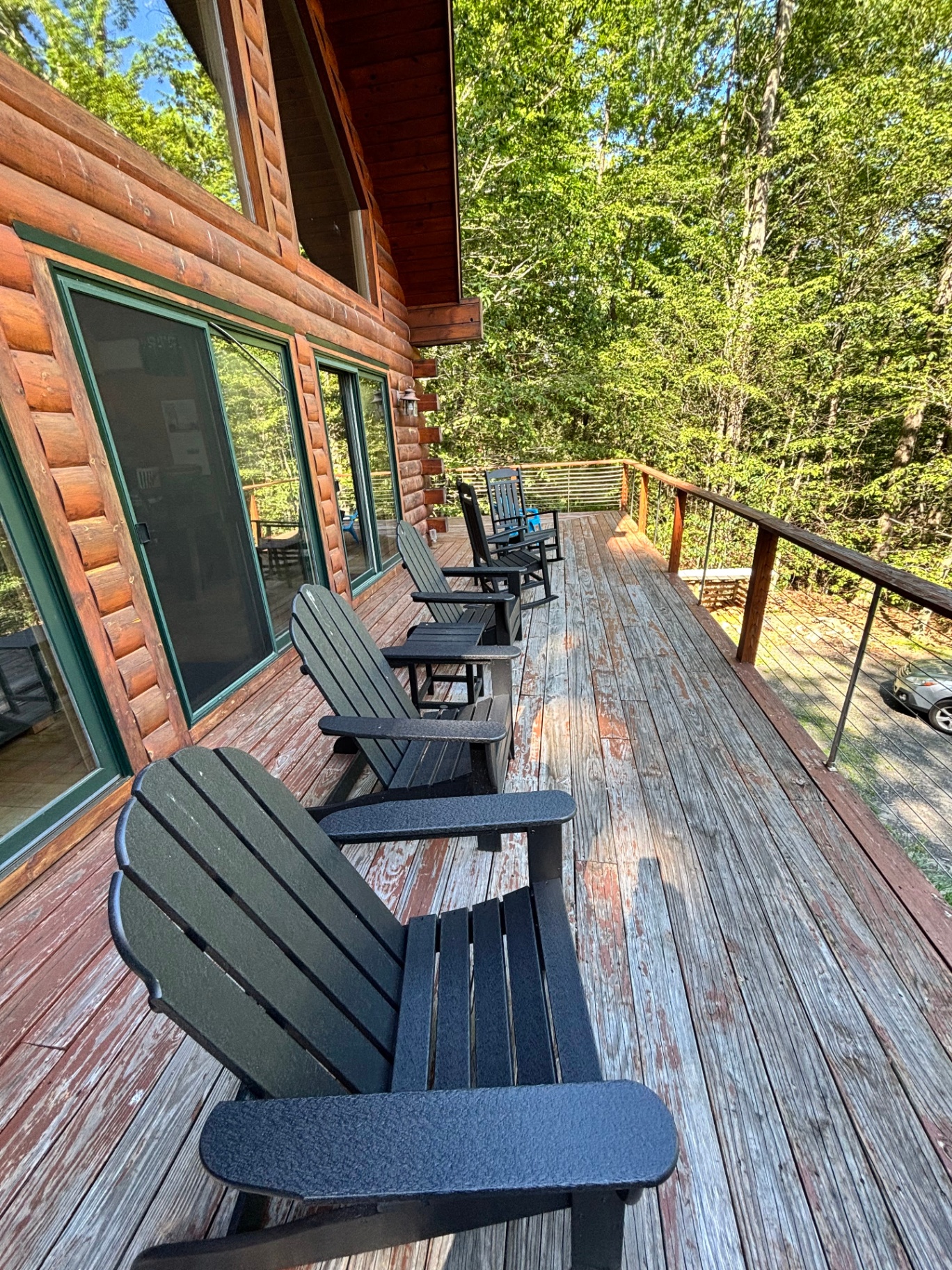 Adirondack chairs and rocking chairs on the wraparound deck