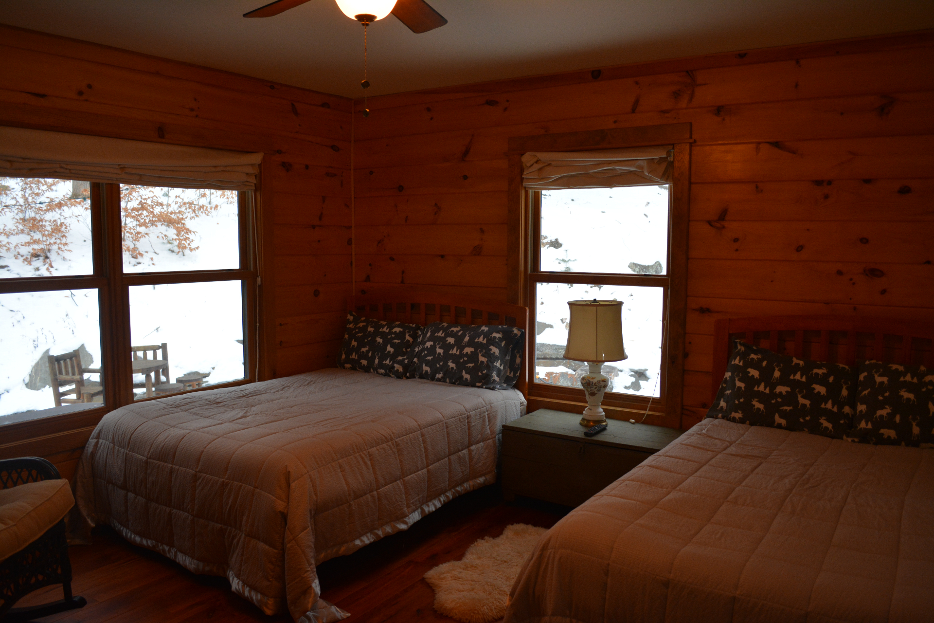 Wood-paneled bedroom with two full beds